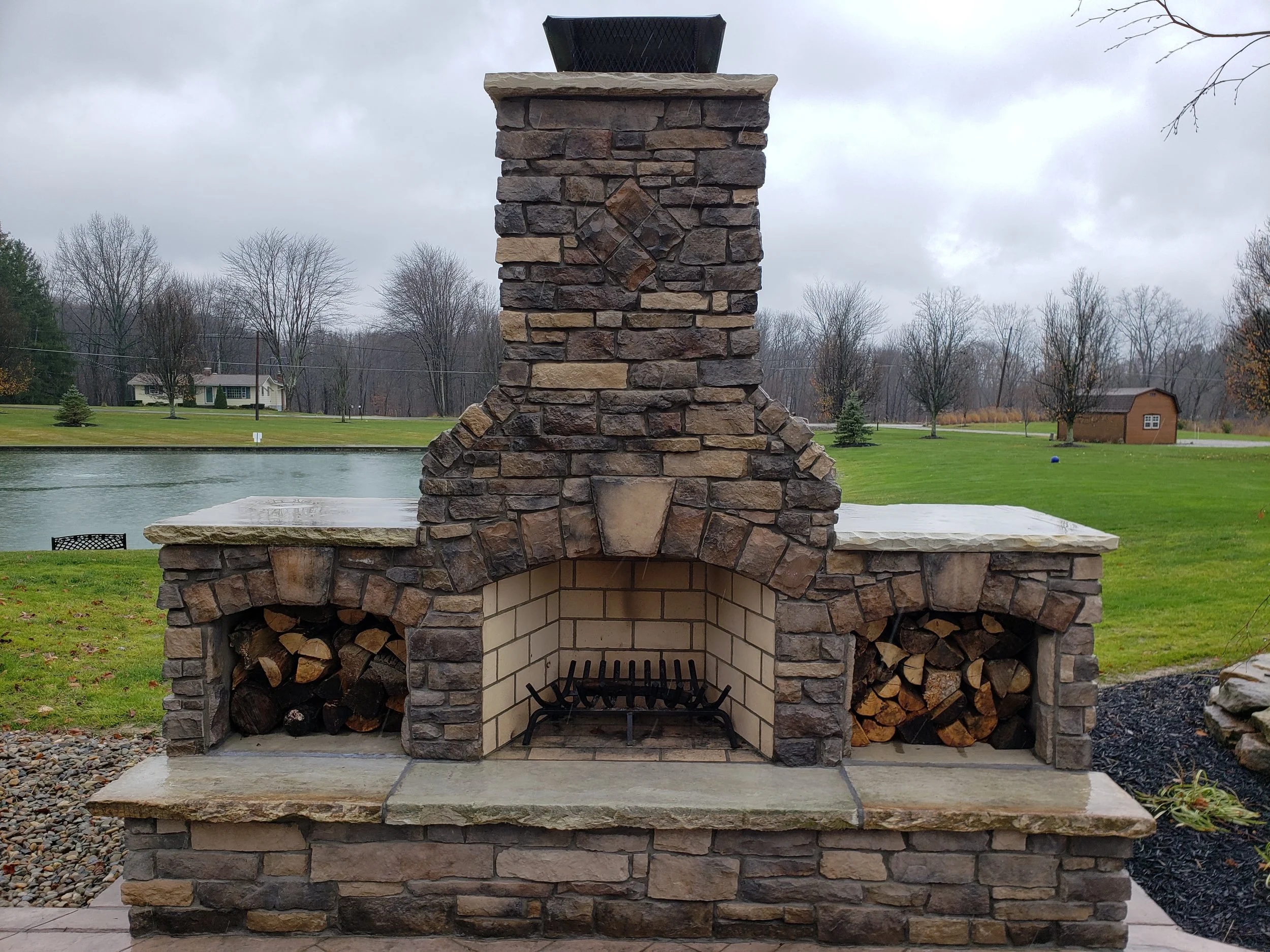 Outdoor fireplace with wood storage